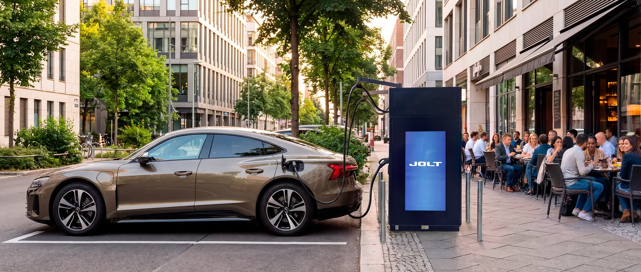 Electric car charging at a JOLT site beside a busy street café